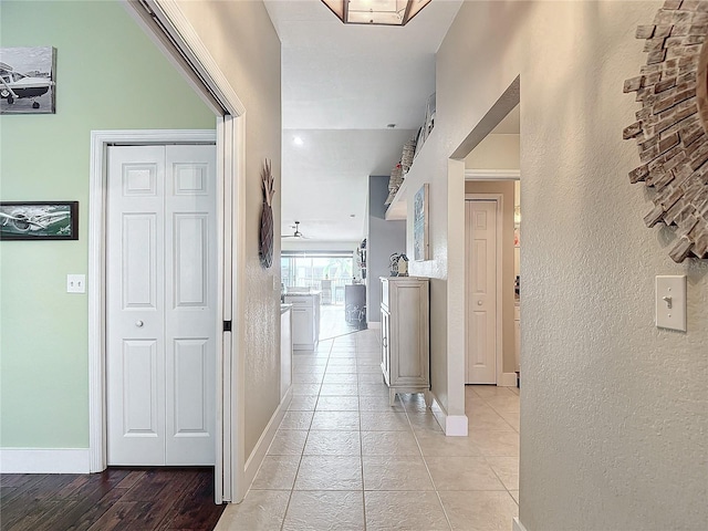 corridor featuring light tile patterned floors