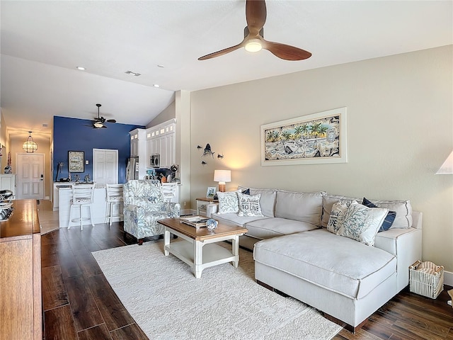 living room featuring lofted ceiling, ceiling fan, and dark hardwood / wood-style floors