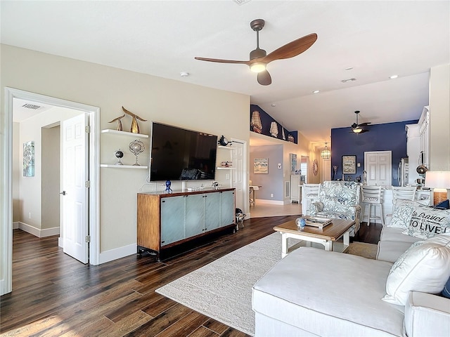 living room featuring ceiling fan, lofted ceiling, and dark hardwood / wood-style flooring