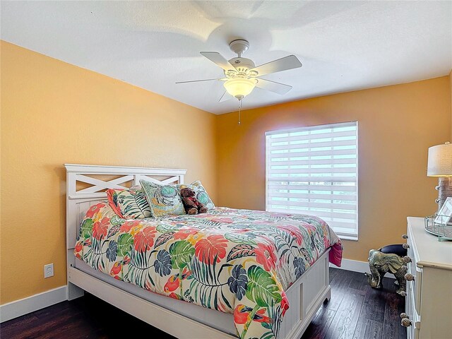 bedroom with ceiling fan and dark wood-type flooring