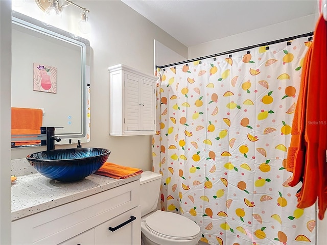 bathroom with vanity, toilet, and curtained shower