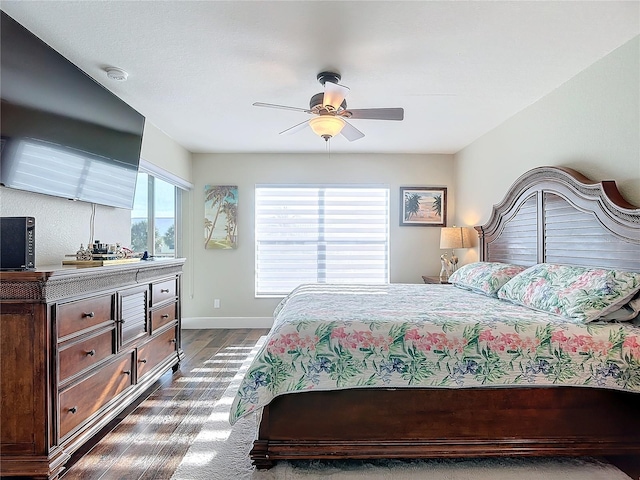 bedroom with dark wood-type flooring and ceiling fan