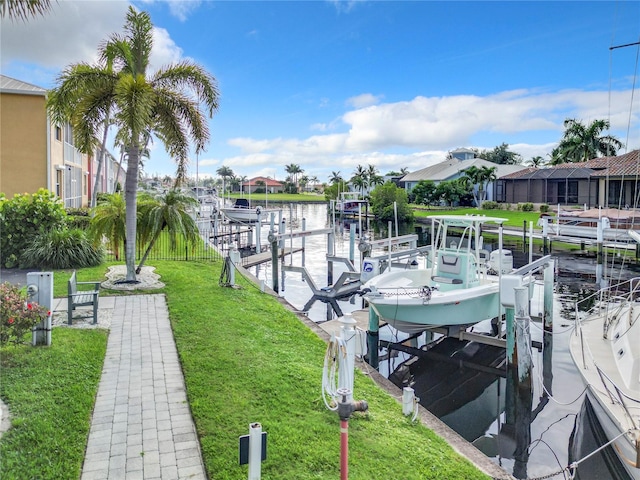 dock area with a water view and a yard