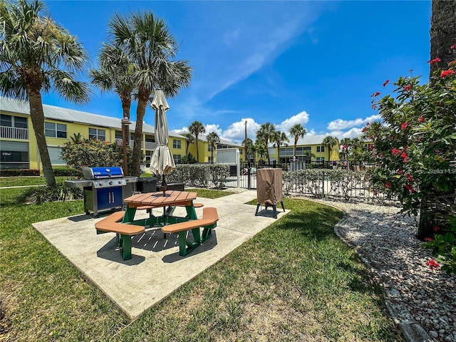 surrounding community with a lawn and a patio area