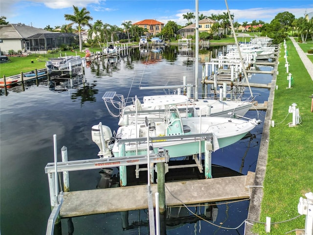 view of dock featuring a lawn and a water view