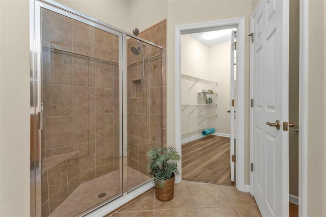 bathroom featuring tile patterned flooring and a shower with door