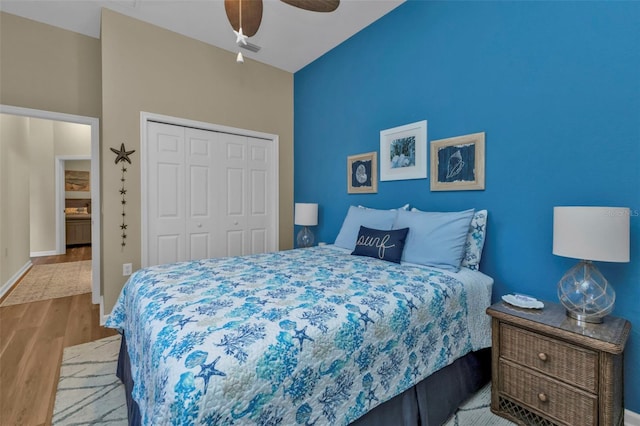 bedroom featuring ceiling fan, light hardwood / wood-style floors, and a closet