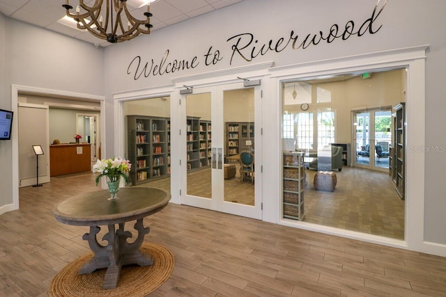 doorway to outside featuring french doors and an inviting chandelier