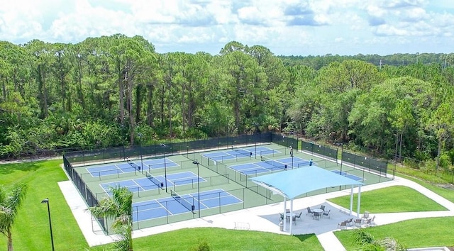 view of sport court featuring a lawn