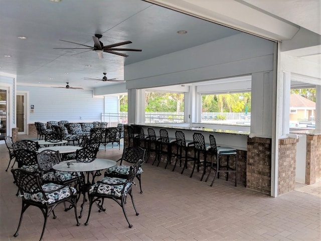 dining space with a wealth of natural light and ceiling fan