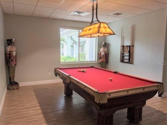 rec room featuring pool table, a drop ceiling, and hardwood / wood-style flooring