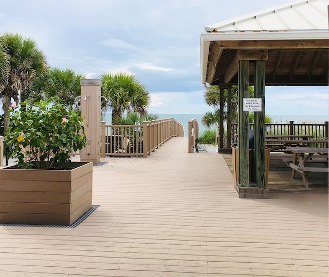 wooden terrace featuring a gazebo and a water view