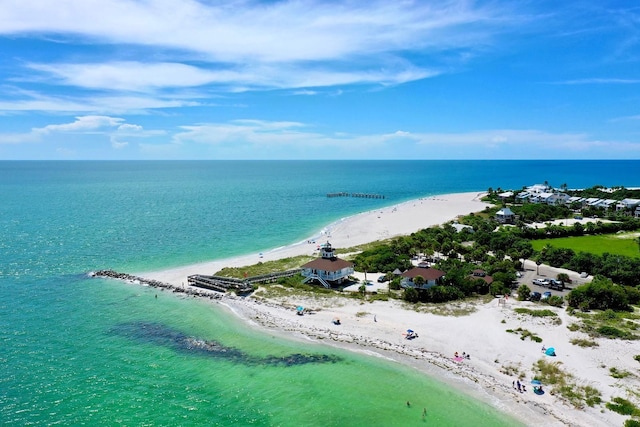 bird's eye view with a water view and a beach view