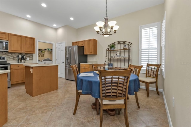 dining area with light tile patterned flooring and a chandelier