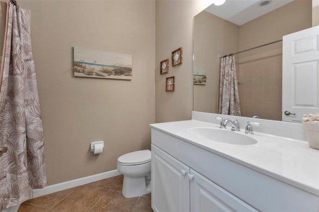 bathroom with a shower with curtain, vanity, toilet, and tile patterned floors