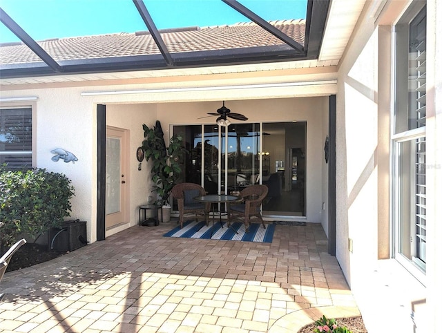 view of patio featuring a lanai and ceiling fan