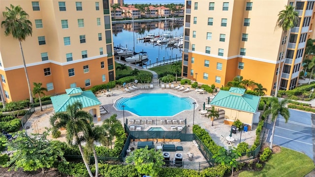 view of pool featuring a water view and a patio