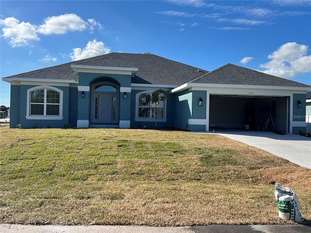 ranch-style home featuring a garage and a front lawn