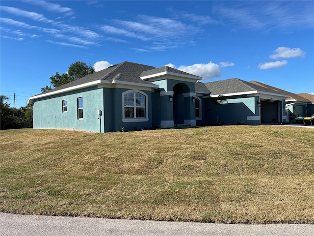 view of front facade with a front yard and a garage