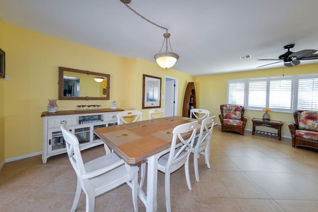 tiled dining space with ceiling fan