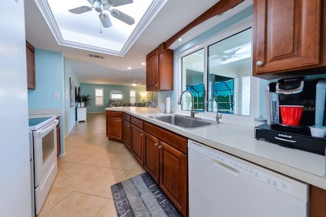 kitchen featuring light tile patterned floors, white appliances, sink, and ceiling fan