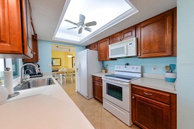 kitchen featuring ceiling fan, a raised ceiling, light tile patterned floors, sink, and white appliances