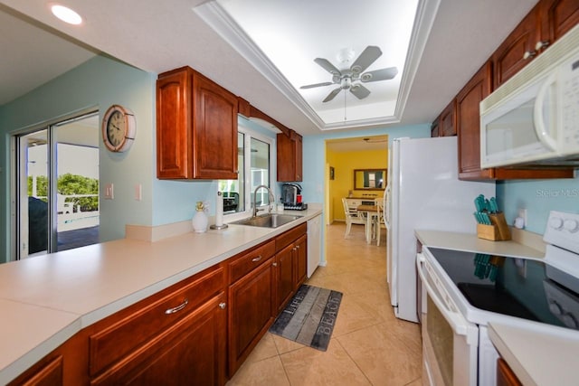 kitchen with white appliances, sink, ceiling fan, and a wealth of natural light