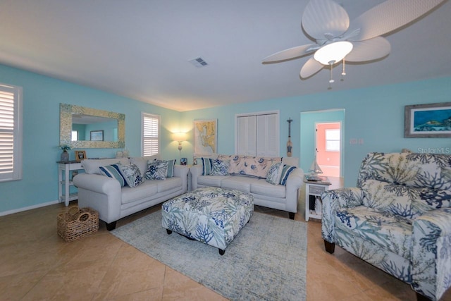 living room featuring ceiling fan and light tile patterned floors