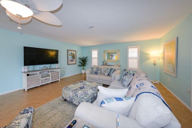 living room with ceiling fan and light tile patterned floors