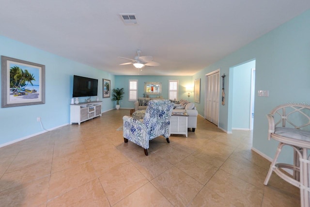 living room featuring light tile patterned floors and ceiling fan