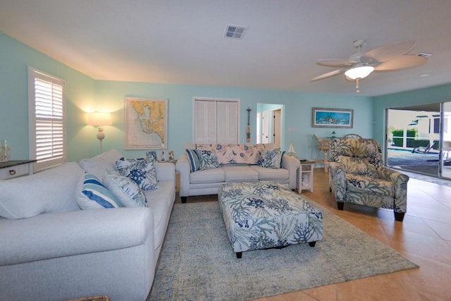 living room featuring light tile patterned flooring and ceiling fan