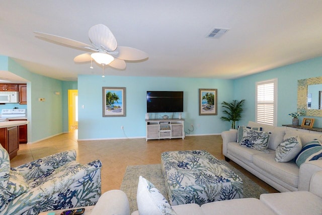 tiled living room featuring ceiling fan