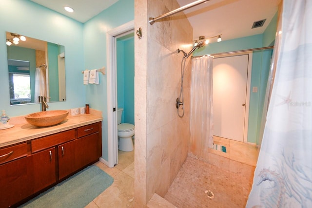 bathroom featuring walk in shower, vanity, and toilet