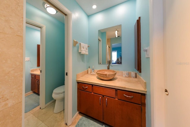 bathroom with tile patterned floors, vanity, and toilet