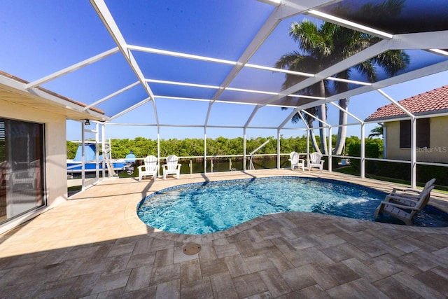 view of pool featuring glass enclosure, a patio, and pool water feature