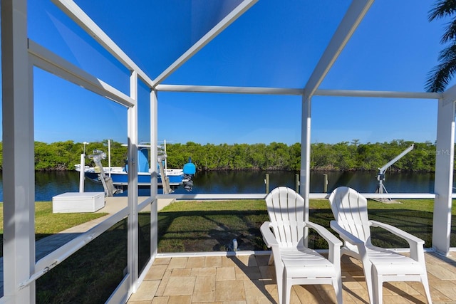 sunroom featuring a water view