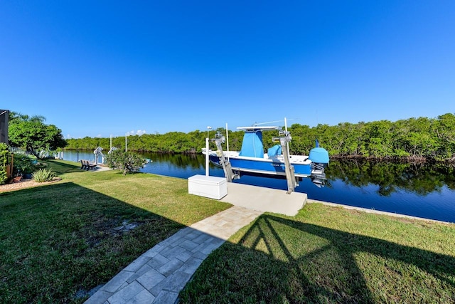 view of yard featuring a water view and a dock