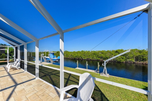 sunroom / solarium featuring a water view