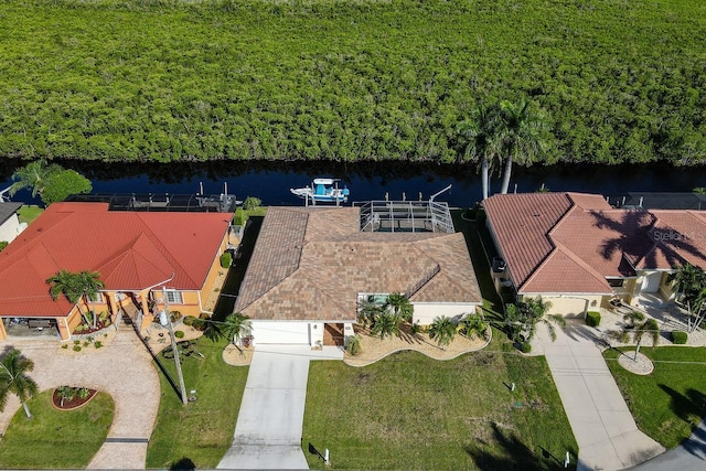 birds eye view of property with a water view