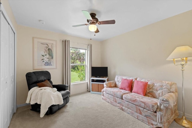 carpeted living room with ceiling fan