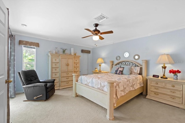 carpeted bedroom featuring ceiling fan and ornamental molding