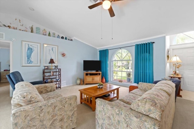 living room with lofted ceiling, light colored carpet, ceiling fan, and ornamental molding