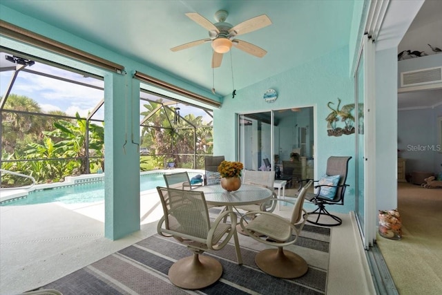 sunroom / solarium with lofted ceiling, a swimming pool, and ceiling fan