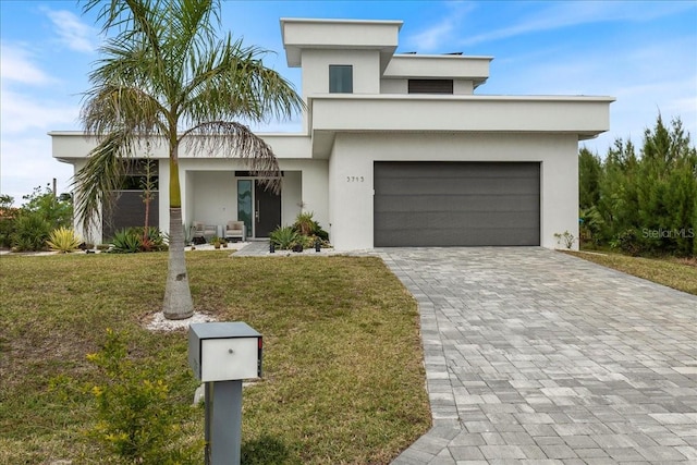 view of front of property featuring a garage and a front yard