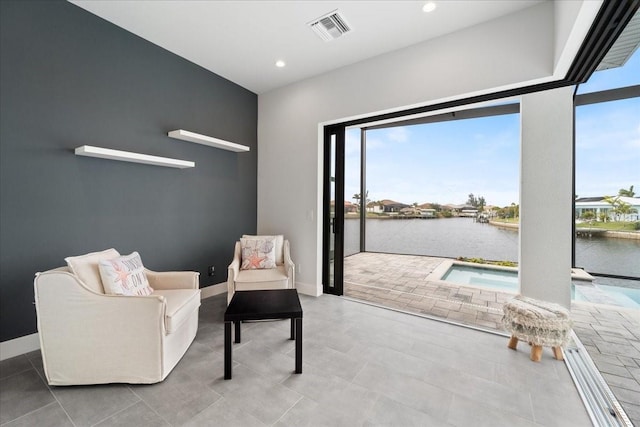 sitting room featuring a water view