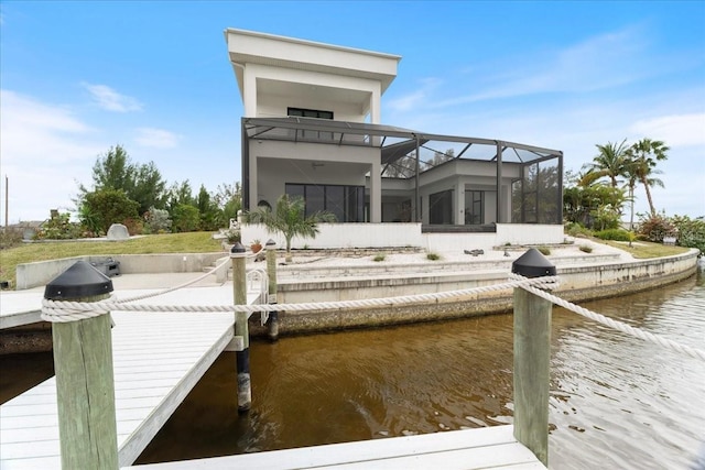 dock area featuring a water view and glass enclosure