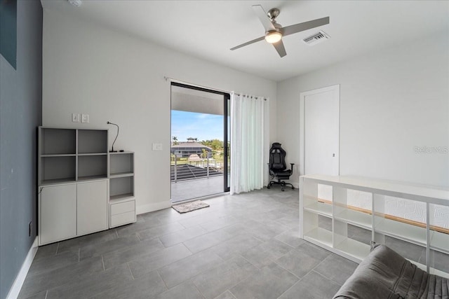 interior space with ceiling fan