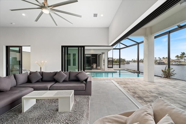 view of swimming pool with a water view and ceiling fan