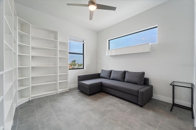 sitting room with tile patterned floors and ceiling fan