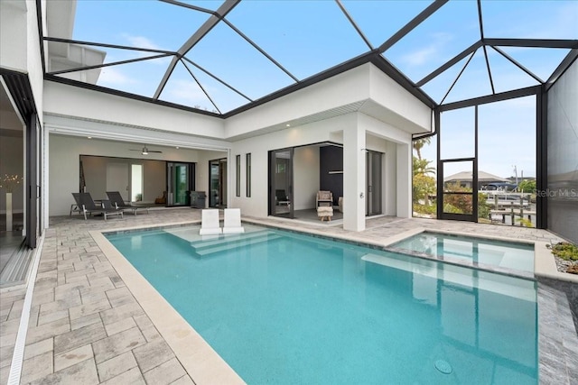 view of pool featuring a patio, ceiling fan, and glass enclosure